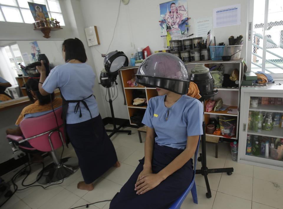 In this Jan. 6, 2017 photo, transgender inmates take a hair salon lesson at Pattaya Remand Prison in Pattaya, Chonburi province, Thailand. The prison separates lesbian, gay, bisexual and transgender prisoners from other inmates, a little-known policy despite being in place nationwide since 1993, according to the Department of Corrections. (AP Photo/Sakchai Lalit)