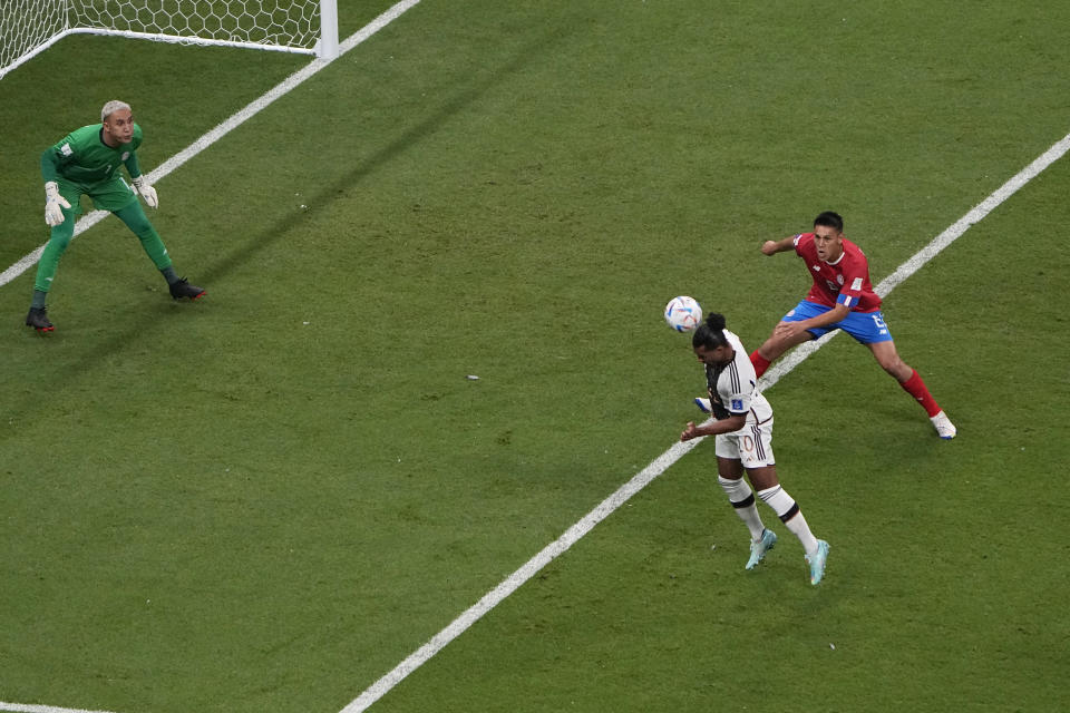 Germany's Serge Gnabry, centre, scores the opening goal tase Costa Rica's goalkeeper Keylor Navas during the World Cup group E soccer match between Costa Rica and Germany at the Al Bayt Stadium in Al Khor, Qatar, Thursday, Dec. 1, 2022. (AP Photo/Ariel Schalit)