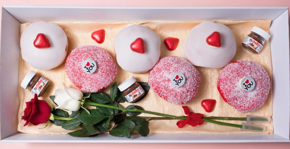 Six donuts with two long stem roses 