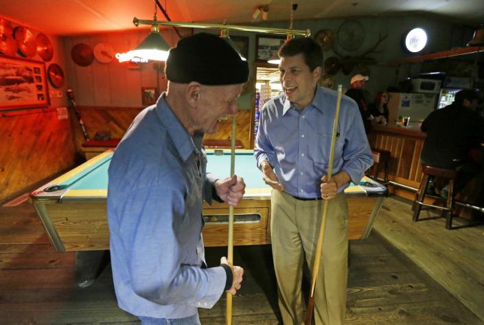 In this Oct. 10, 2014 photo, U.S. Sen. Mark Begich, right, D-Alaska, jokes with Jimmy Maddox, left, after Maddox challenged the senator to a game of pool at Kito&#39;s Kave, a bar in Petersburg, Alaska. Begich had stopped at the bar to get a late-night burger after a full day of campaigning. (AP Photo/Ted S. Warren)