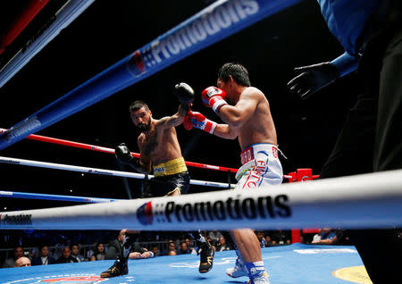 Boxing - WBA Welterweight Title Fight - Manny Pacquiao v Lucas Matthysse - Axiata Arena, Kuala Lumpur, Malaysia - July 15, 2018 Manny Pacquiao in action against Lucas Matthysse REUTERS/Lai Seng Sin