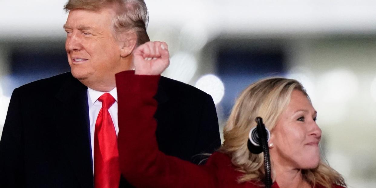 Republican Rep. Marjorie Taylor Greene of Georgia speaks with then-President Donald Trump at a campaign rally in support of Georgia Republican Sens. Kelly Loeffler and David Perdue in Dalton, GA on January 4, 2021.