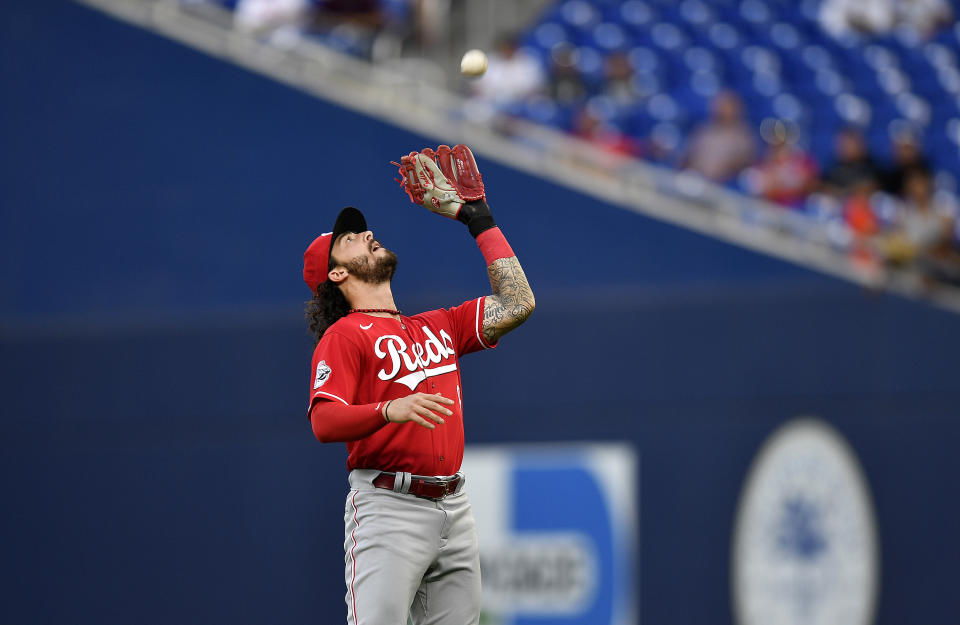 Cincinnati Reds second baseman Jonathan India catches a fly ball hit by Miami Marlins' Jorge Soler during the first inning of a baseball game Friday, May 12, 2023, in Miami (AP Photo/Michael Laughlin)