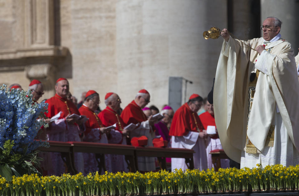 Pope Francis incenses the faithful as he arrives to celebrate an Easter Sunday Mass in St. Peter's Square at the Vatican Sunday, April 20, 2014. (AP Photo/Andrew Medichini)