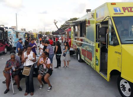 Food trucks are seen during this month's Art Walk in the Miami neighborhood of Wynwood October 11, 2014. REUTERS/Andrew Innerarity