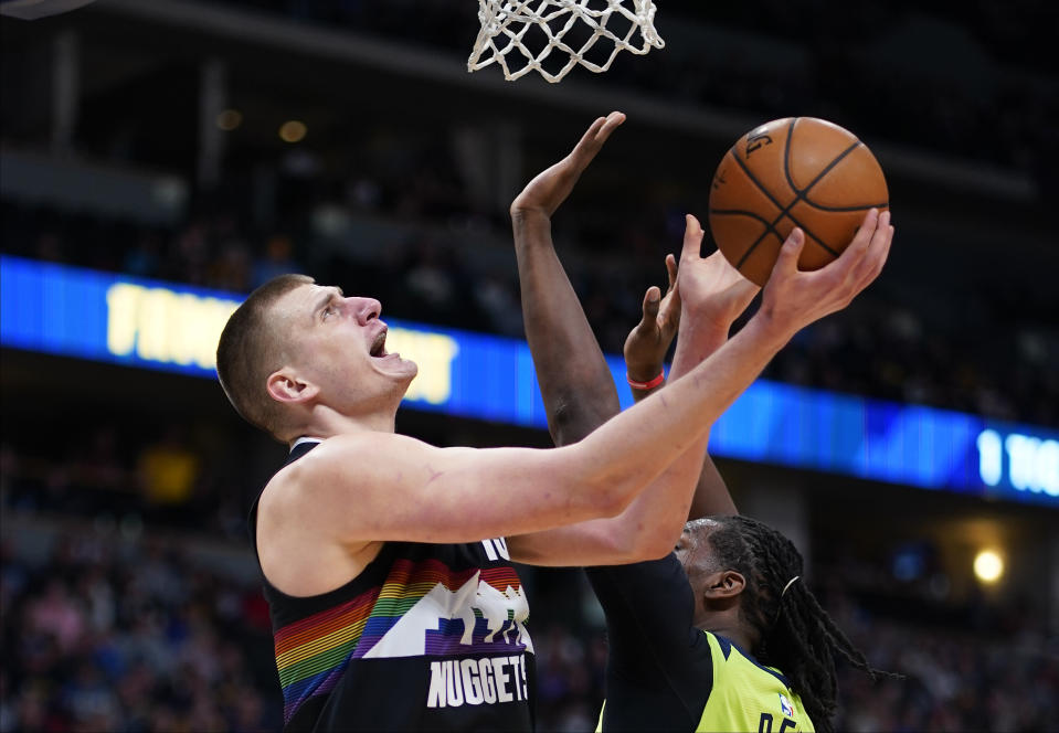 Denver Nuggets center Nikola Jokic (15) goes up for a shot against Minnesota Timberwolves center Naz Reid (11) during the third quarter of an NBA basketball game Sunday, Feb. 23, 2020, in Denver (AP Photo/Jack Dempsey)