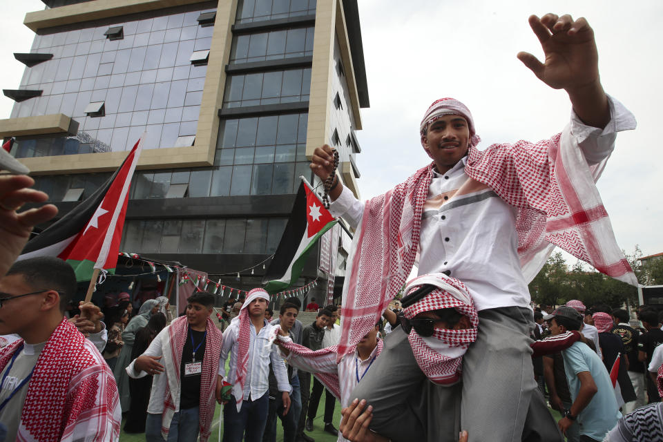 A man dances in anticipation of the royal motorcade in Amman, Jordan, on Thursday, June 1, 2023, just ahead of Crown Prince Hassan and saudiSaudi architect Rajwa Alseif's wedding. (AP Photo/Raad Adayleh)