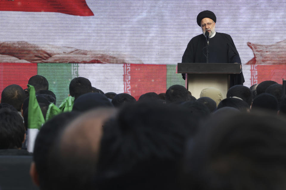 Iranian President Ebrahim Raisi speaks during a funeral procession for a group of unknown Iranian soldiers who were killed during the 1980-88 Iran-Iraq war, whose remains were recently recovered in the battlefields, in Tehran, Iran, Tuesday, Dec. 27, 2022. (AP Photo/Vahid Salemi)