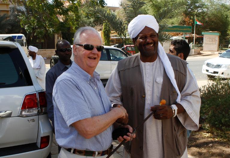 Robert Gordon (L), a relative of General Charles Gordon, is greeted by Abdel Rahman Sadiq Al-Mahdi, one of the Mahdi's descendants, upon his arrival at Khartoum's Republican Palace, on February 7, 2014