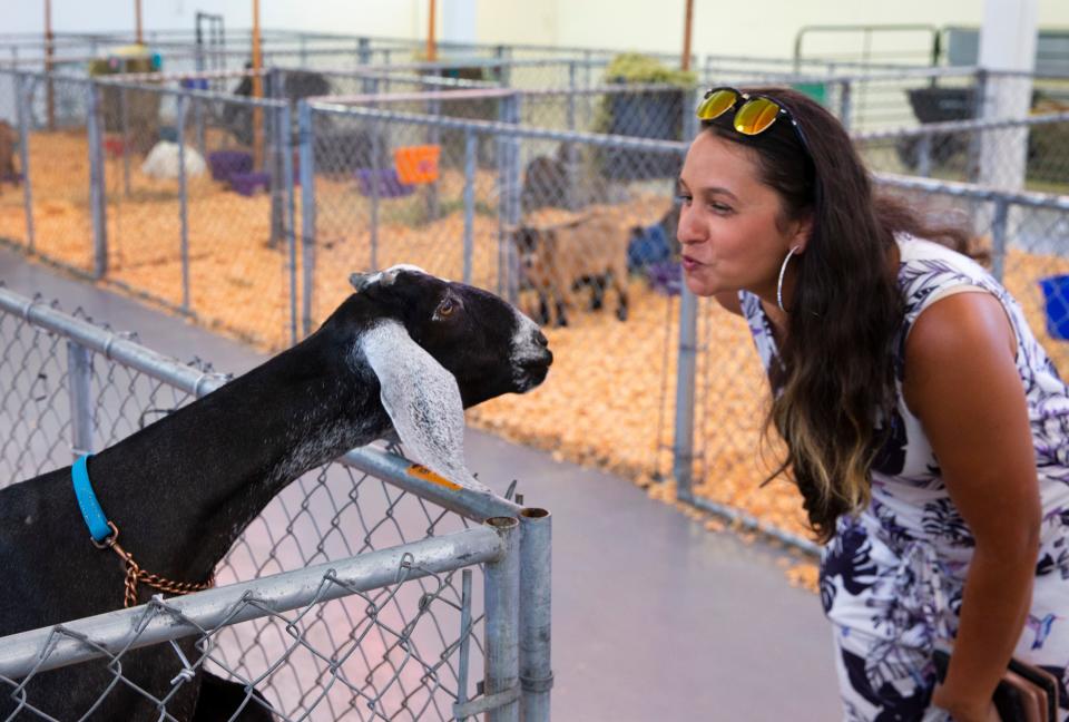 Ruth Eve, from Eugene, blows a kiss to a goat during a tour of the animal barns at the Lane County Fair Wednesday, July 20, 2022. The fair at the Lane Events Center fairgrounds runs through Sunday, July 24.