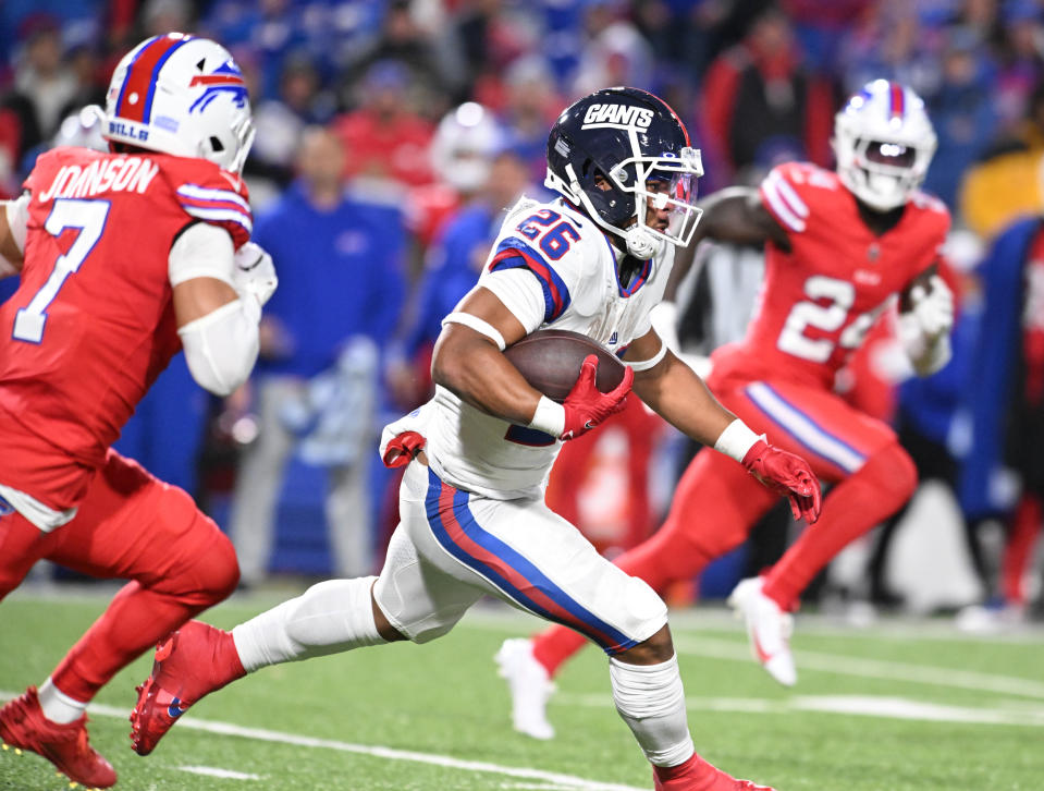 New York Giants running back Saquon Barkley (26) runs the ball against the <a class="link " href="https://sports.yahoo.com/nfl/teams/buffalo/" data-i13n="sec:content-canvas;subsec:anchor_text;elm:context_link" data-ylk="slk:Buffalo Bills;sec:content-canvas;subsec:anchor_text;elm:context_link;itc:0">Buffalo Bills</a> in the third quarter at Highmark Stadium. Mandatory Credit: Mark Konezny-USA TODAY Sports