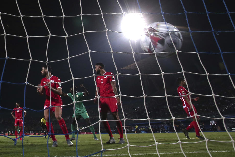 Senegal players celebrates after Tunisia's Dylan Bronn, second right, scores an own goal during the African Cup of Nations semifinal soccer match between Senegal and Tunisia in 30 June stadium in Cairo, Egypt, Sunday, July 14, 2019. (AP Photo/Hassan Ammar)