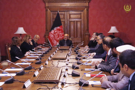 Afghanistan's President Ashraf Ghani (C) talks with the U.S. special envoy for peace in Afghanistan, Zalmay Khalilzad (L), during a meeting in Kabul, Afghanistan January 27, 2019. Presidential Palace office/Handout via REUTERS