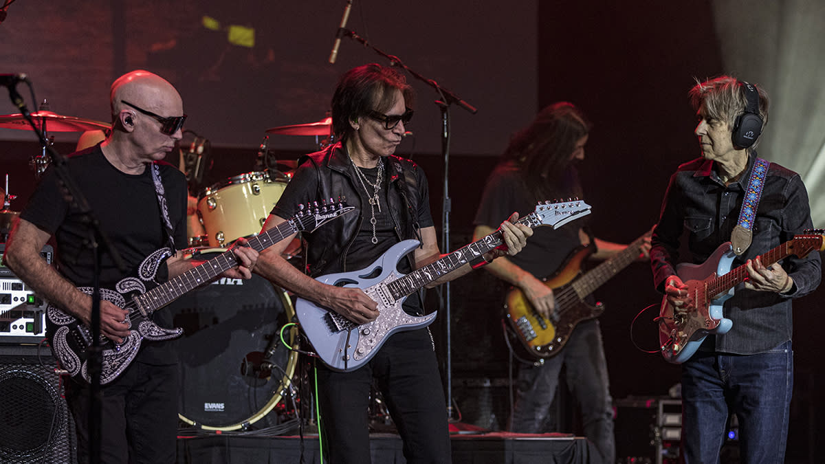  Eric Johnson, Joe Satriani and Steve Vai performing at a 2024 G3 concert. 