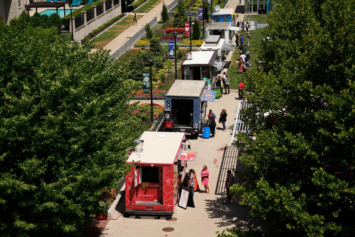 Diners order lunch from one of the various options during the Food Truck Food Court at the Columbus Commons on Thursday.