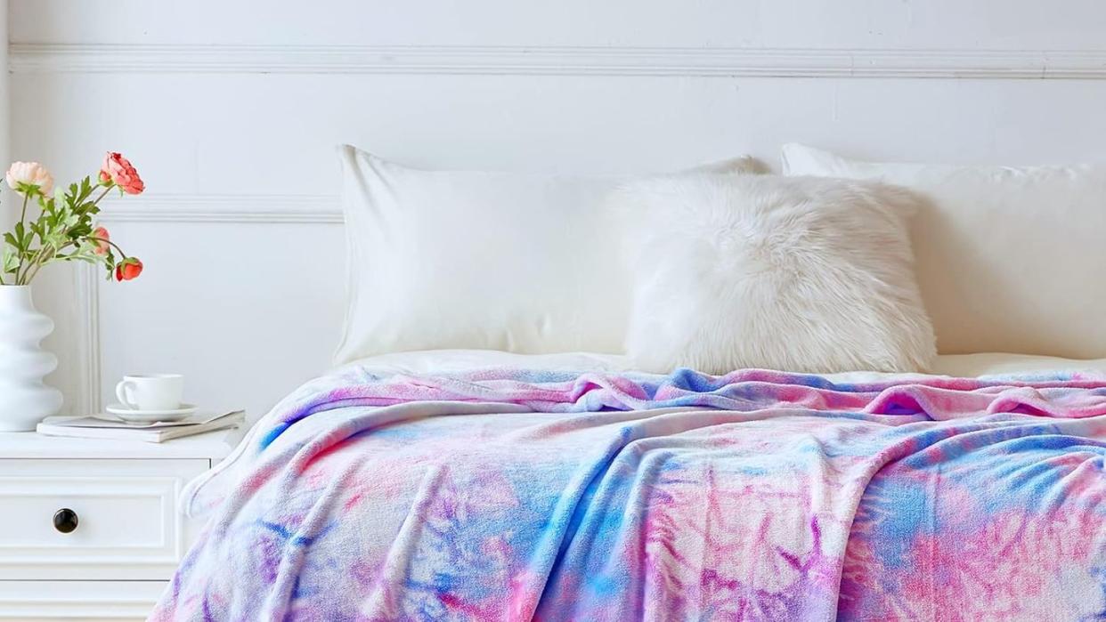 a bed with a pink and white comforter