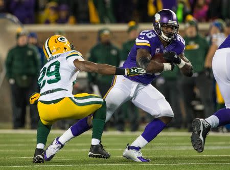 Minnesota Vikings running back Adrian Peterson (28) carries the ball during the fourth quarter against the Green Bay Packers at TCF Bank Stadium. The Packers defeated the Vikings 30-15. Mandatory Credit: Brace Hemmelgarn-USA TODAY Sports