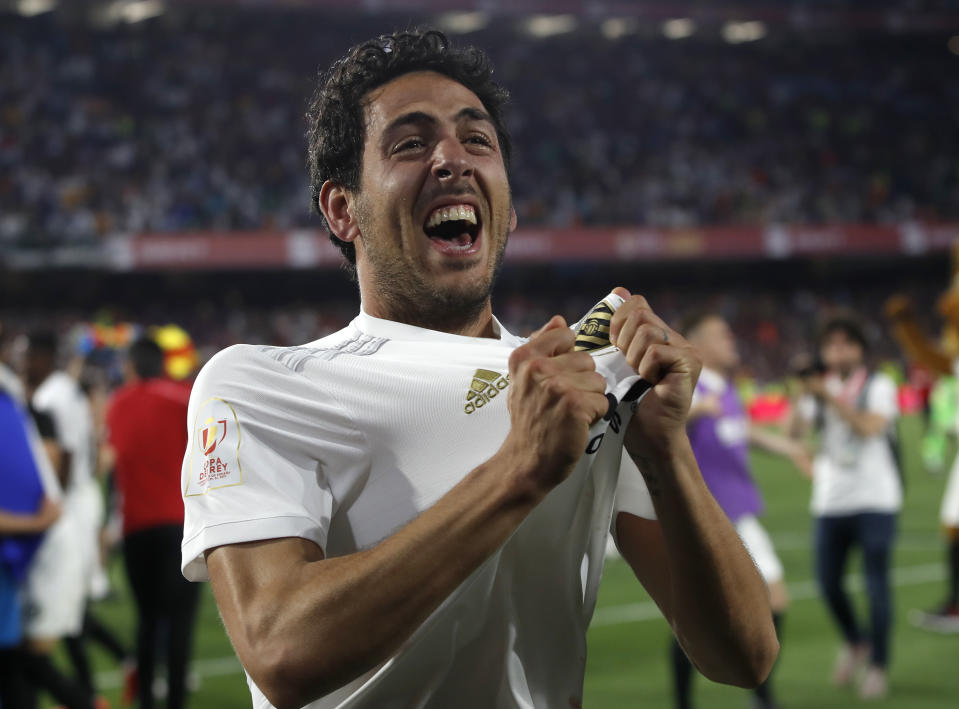 Valencia midfielder Daniel Parejo celebrates after his team's win in the Copa del Rey soccer match final between Valencia CF and FC Barcelona at the Benito Villamarin stadium in Seville, Spain, Saturday. 25, 2019. (AP Photo/Miguel Morenatti)