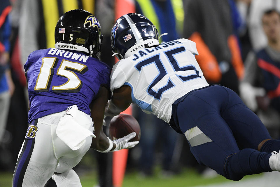 Baltimore Ravens wide receiver Marquise Brown (15) works for a catch against Tennessee Titans cornerback Adoree' Jackson (25) during the first half an NFL divisional playoff football game, Saturday, Jan. 11, 2020, in Baltimore. (AP Photo/Nick Wass)