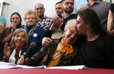 Javier Matias Darroux Mijalchuk, son of Elena Mijalchuk and Juan Manuel Darroux, who disappeared during Argentina's former 1976-1983 dictatorship, comforts the president of human rights organisation de Carlotto, during a news conference in Buenos Aires