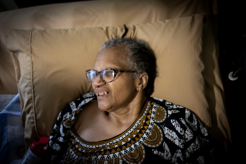 Constance Guthrie, reacts as her daughter, Jessica, cleans beneath her fingernails as part of their morning routine shortly after she wakes up, in Fredericksburg, Va., on Tuesday, Sept. 20, 2022. Lost in her own mind, Constance can no longer testify to the difficulties she endured -- as a mother, a Black entrepreneur running a business on her own. But her daughter, Jessica, can attest to the struggles she’s had, as a Black caregiver, trying to ensure that her mother receives appropriate care. (AP Photo/Wong Maye-E)