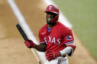 Texas Rangers' Adolis Garcia walks out of the batters box after swinging at a pitch in the seventh inning of a baseball game against the Chicago White Sox in Arlington, Texas, Friday, Sept. 17, 2021. Garcia struck out in the at-bat. (AP Photo/Tony Gutierrez)