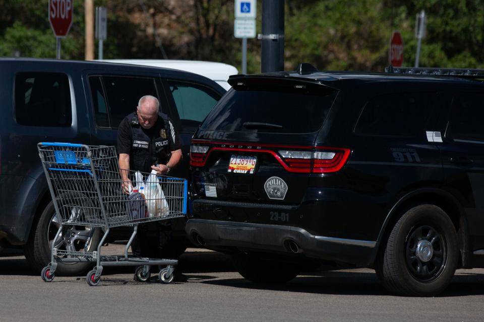 Ruidoso Downs Police Chief Commander grabs his groceries on June 24, 2024 as normalcy begins to return to the area after fires destroyed homes in neighboring Village of Ruidoso.