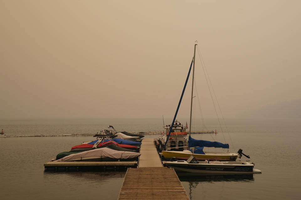 FILE - In this Tuesday, Aug. 24, 2021 file photo, smoke from the Caldor Fire, shrouds Fallen Leaf Lake near South Lake Tahoe, Calif. Last week, managers overseeing the fight against the massive wildfire scorching California's Lake Tahoe region thought they could have it contained by the start of this week. Instead, on Monday, Aug. 30, 2021, the Caldor Fire crested the Sierra Nevada, forcing the unprecedented evacuation of all 22,000 residents of South Lake Tahoe. (AP Photo/Rich Pedroncelli, File)