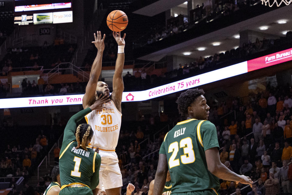 Tennessee guard Josiah-Jordan James (30) shoots over George Mason guard Ronald Polite III (1) during the first half of an NCAA college basketball game Tuesday, Dec. 5, 2023, in Knoxville, Tenn. (AP Photo/Wade Payne)