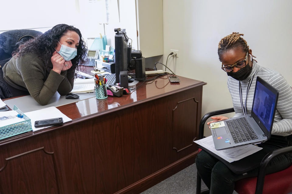 High School Councilor Nadia Pearce, right, and Coordinator of School Counseling Carli Rocha-Reaes speak to a group of Juniors and Seniors via video conference, Thursday, Feb. 25, 2021, in Bridgeport. Conn. School counselors in many urban, high needs districts have been consumed with efforts to help students engage with their schoolwork since the pandemic hit. (AP Photo/Mary Altaffer)