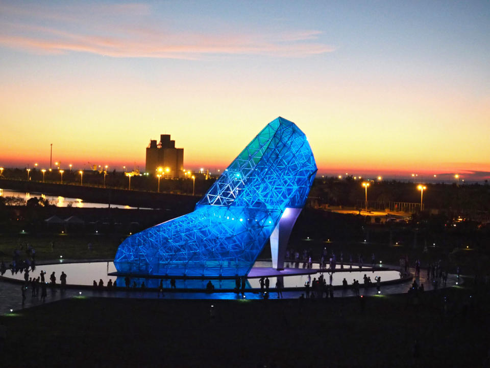 <p>People visit the High-Heeled Shoe Church in Chiayi, western Taiwan, July 23, 2016. The church, costing $7.6 million, is made with 320 pieces of blue glass and a steel frame. It is 17 meters tall, 11 meters wide, 25 meters long and is certified by the Guinness Word Records as ‘the largest buliding shaped like a shoe.’ (Photo: DAVID CHANG/EPA)</p>