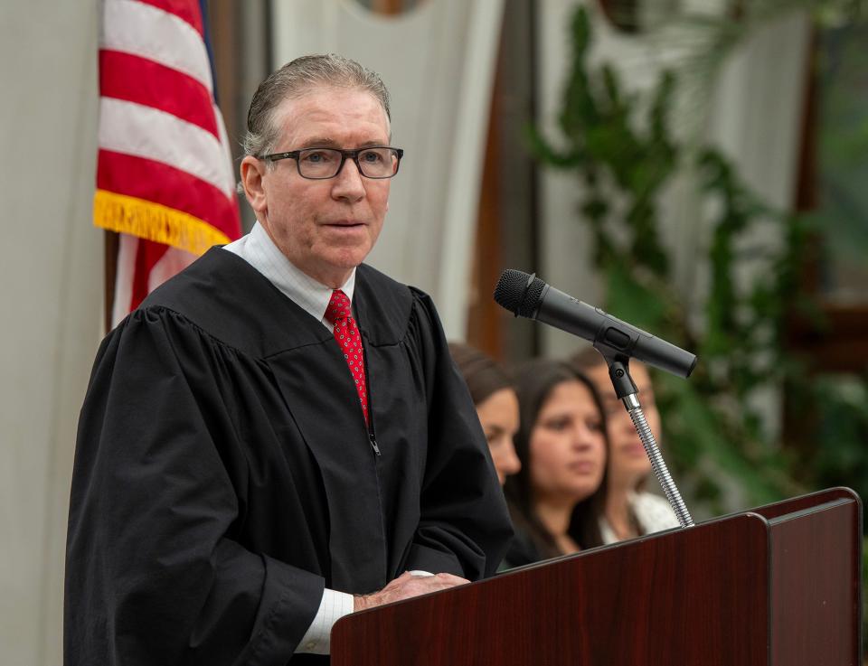 The Honorable David H. Hennessy speaks to newly naturalized citizens during a ceremony Wednesday at the New England Botanic Garden at Tower Hill in Boylston.