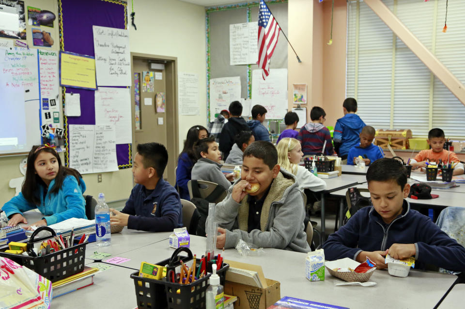 In this Wednesday, April 8, 2015 photo, students are served breakfast at the Stanley Mosk Elementary School in Los Angeles. In this Los Angeles Unified School District program, and in other major urban school districts, breakfast is increasingly being served inside the classroom. The number of breakfasts served in the nation’s schools has doubled in the last two decades, a surge driven largely by a change in how districts deliver the food. Instead of providing low-income students free or reduced-price meals in the cafeteria, they’re increasingly serving all children in the classroom. (AP Photo/Nick Ut)