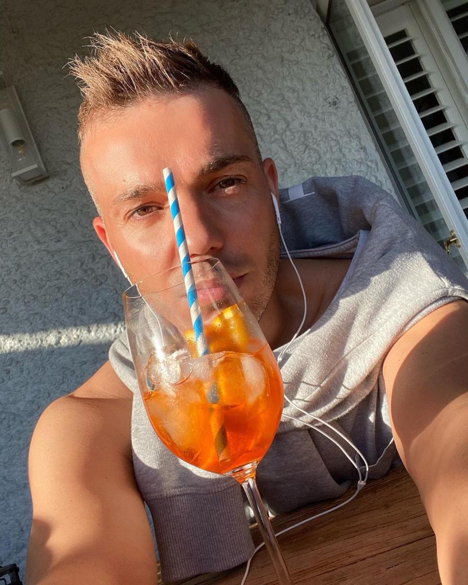 Anthony Callea takes a selfie with a cocktail