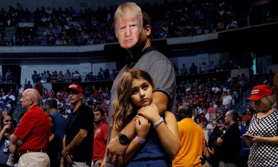 Thomas Musolino holds his daughter Gianna during a Trump rally in Wilkes-Barre, Pennsylvania in August.