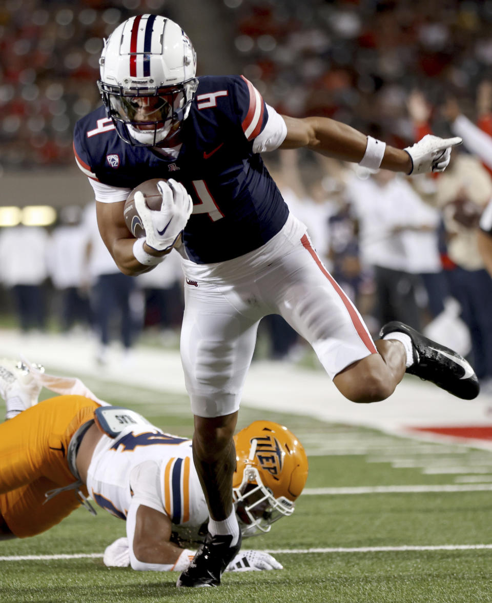 Arizona wide receiver Tetairoa McMillan (4) dances his way into the end zone after a catch during the first half of an NCAA college football game against UTEP on Saturday, Sept. 16, 2023, in Tucson, Ariz. (Kelly Presnell/Arizona Daily Star via AP)