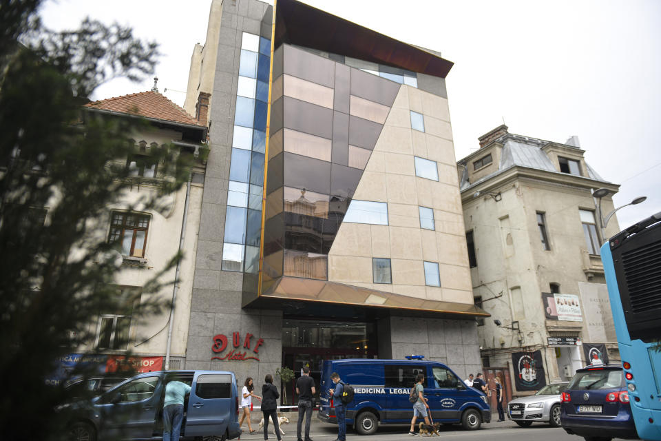 Police cars are parked outside the Duke Hotel where Gholamreza Mansouri died after falling from a high floor inside a hotel, in Bucharest, Romania, Friday, June 19, 2020. Gholamreza Mansouri, a former judge from Iran sought by his country to face corruption charges has died after falling from a high floor inside a hotel. Romanian police said only that a man had fallen from a high floor at a hotel in Bucharest, the Romanian capital, and was found dead. (AP Photo/Andreea Alexandru)