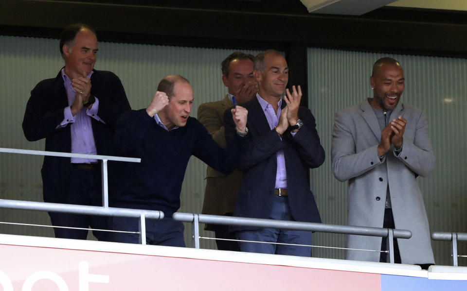 Britain's Prince William, second left, and former footballer John Carew, right, cheer in the stands during the English Championship Play-off soccer final between Aston Villa and Derby County at Wembley Stadium, London, Monday, May 27, 2019. (Mike Egerton/PA via AP)