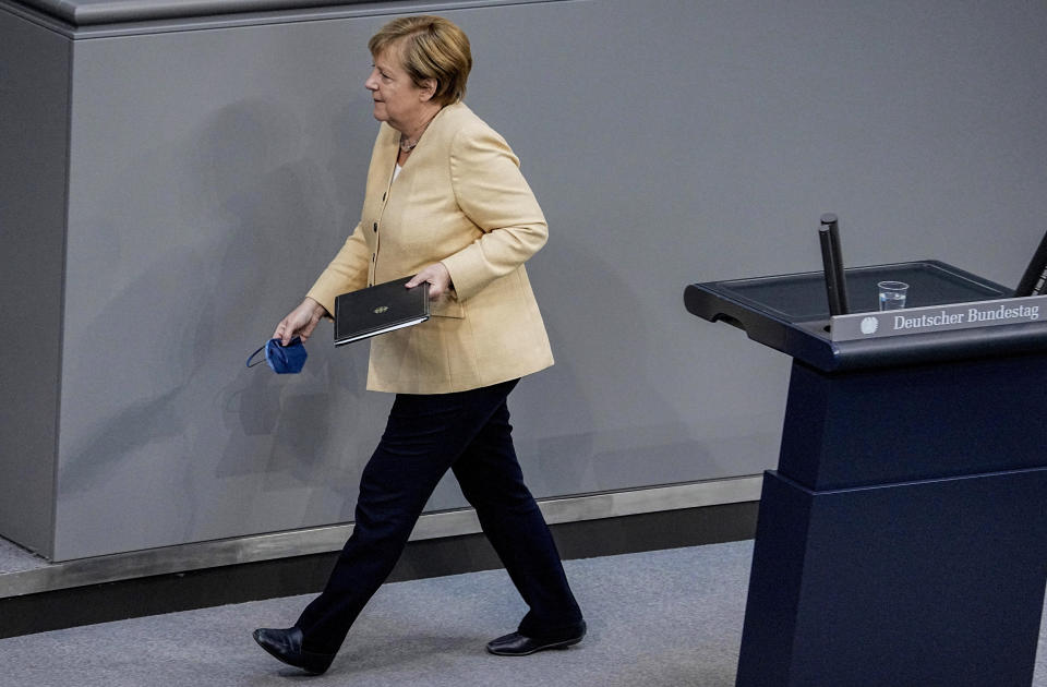 German Chancellor Angela Merkel leaves the lectern after her speech in the plenary session in the German Bundestag in Berlin, Germany, Tuesday, Sept.7, 2021. (Michael Kappeler/dpa via AP)