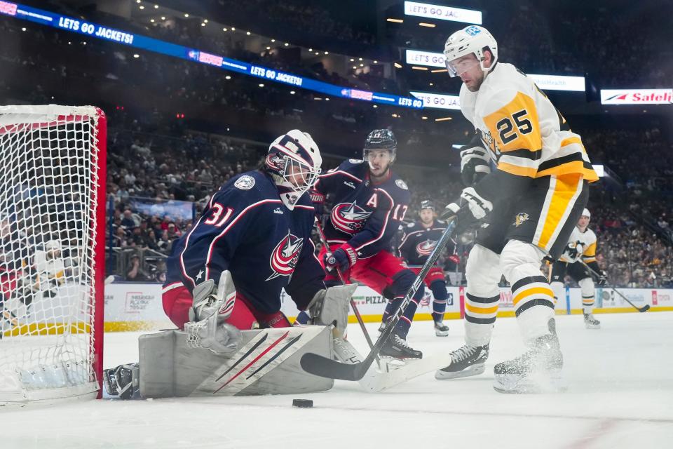 Columbus Blue Jackets goaltender Michael Hutchinson (31) saves a shot from Pittsburgh Penguins center Ryan Poehling (25) during the second period of the NHL hockey game at Nationwide Arena on April 13, 2023.