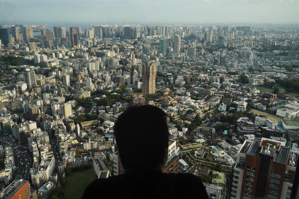 A man watches the cityscape of Tokyo from an observation deck located on the top floor of Roppongi Hills Mori Tower, Thursday, Sept. 19, 2019, in Tokyo. (AP Photo/Jae C. Hong)