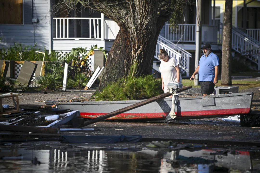 Residents, traveling by boat, inspect Cedar Key after Hurricane Helene made landfall.