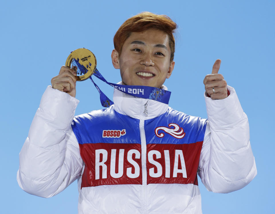 Viktor Ahn, of Russia, gestures while holding his medal during the medals ceremony at the Winter Olympics in Sochi, Russia. (AP)
