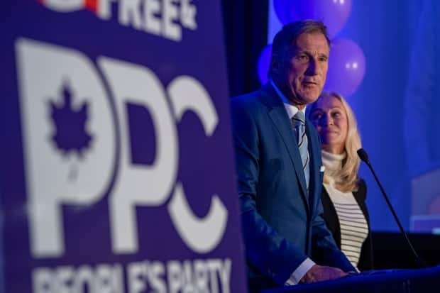 People's Party of Canada Leader Maxime Bernier, with his wife Catherine Letarte, speaks from a podium to supporters during the PPC headquarters election night event in Saskatoon on Sept. 20, 2021.  (Liam Richards/The Canadian Press - image credit)