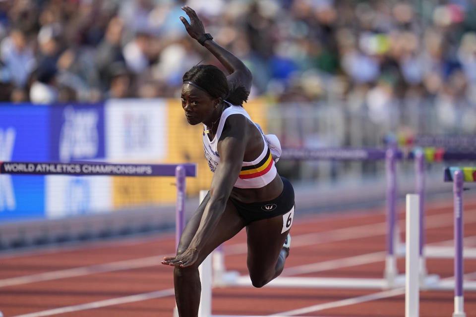 Anne Zagre, of Belgium, competes and falls alone in a heat in the women's 100-meter hurdles at the World Athletics Championships on Saturday, July 23, 2022, in Eugene, Ore. Zagre in lane six got hampered during the race at the 10th hurdle by Nia Ali, of the USA in lane five. Ali of the USA knocked a hurdle over and got in lane six, affecting Zagre. (AP Photo/Ashley Landis)