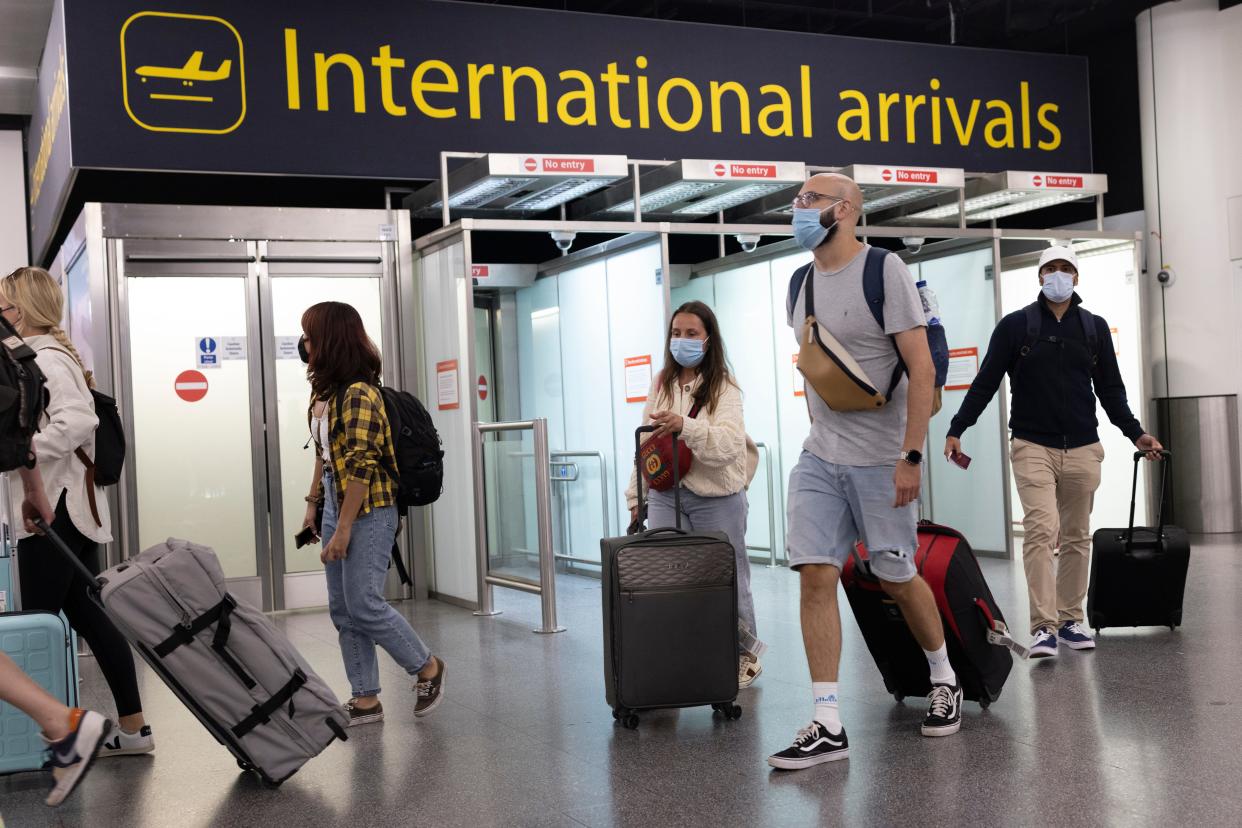 Travelers arrive at Gatwick Airport on July 30, 2021 in London, England. Restrictions to and from the UK remain in place as Coronavirus continues to disrupt global travel.