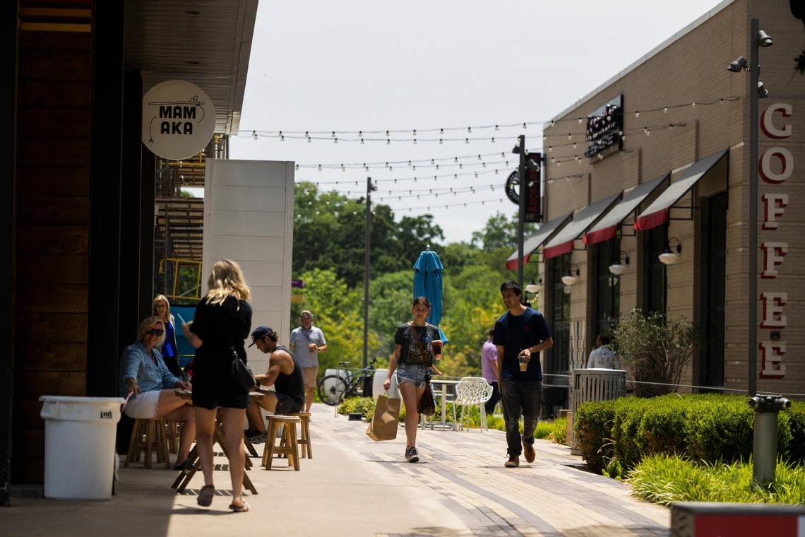 People grab food and shop during lunch hour as temperatures rise above 100 degrees Thursday, July 21, 2022, at WestBend shopping mall in Fort Worth.