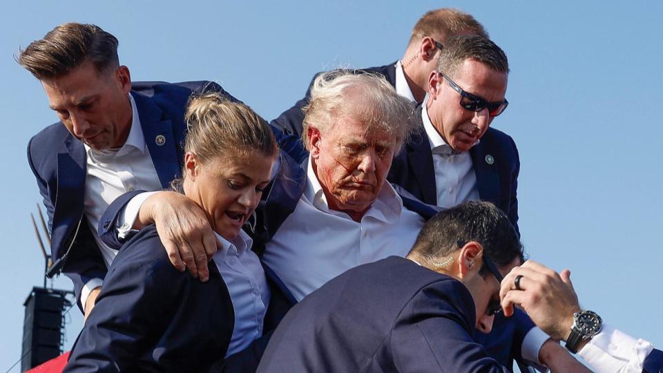 PHOTO: Republican presidential candidate former President Donald Trump is rushed offstage by U.S. Secret Service agents after being grazed by a bullet during a rally on July 13, 2024 in Butler, Pennsylvania. (Anna Moneymaker/Getty Images)