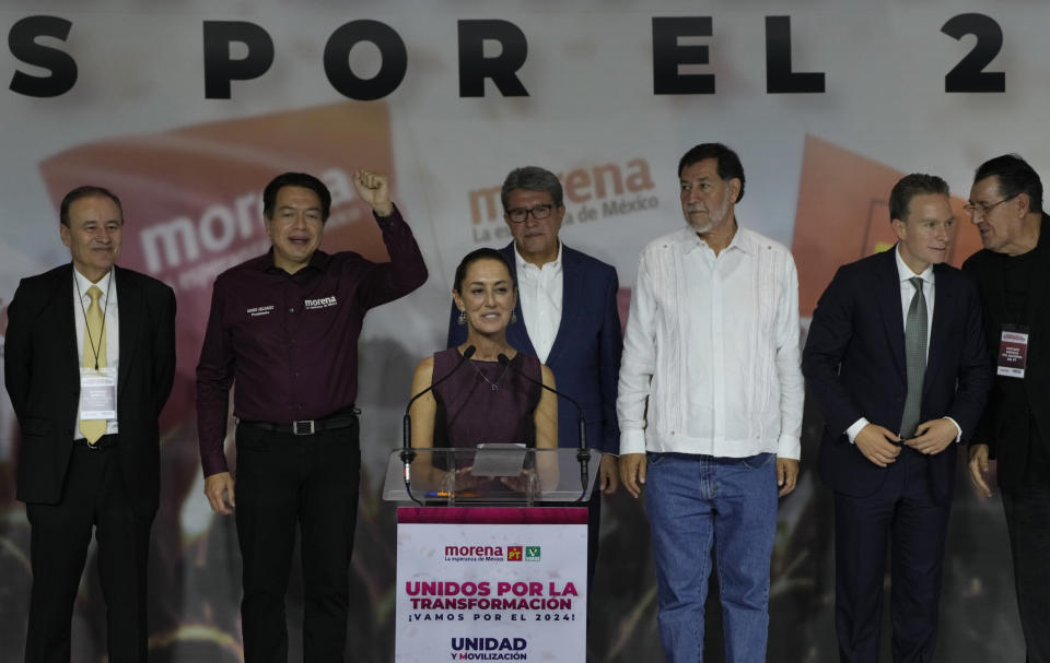 Flanked by party leaders, Claudia Sheinbaum smiles after being elected to be the MORENA party candidate for the upcoming national presidential elections, during an event in Mexico City, Wednesday, Sept. 6, 2023. (AP Photo/Fernando Llano)