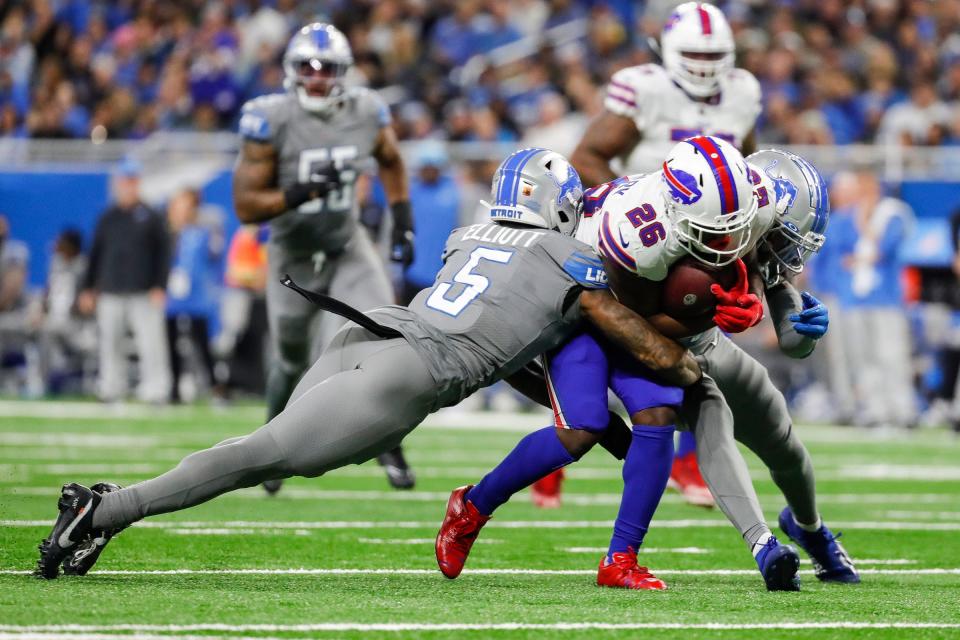 Detroit Lions safety DeShon Elliott (5) stops Buffalo Bills running back Devin Singletary (26) during the first half at Ford Field in Detroit on Thursday, Nov. 24, 2022.